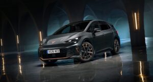 Grey Cupra Born electric hatchback, front three-quarter view, in a dark arched hall