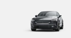 Grey Polestar 2 electric fastback, front three-quarter view, on a light grey studio background